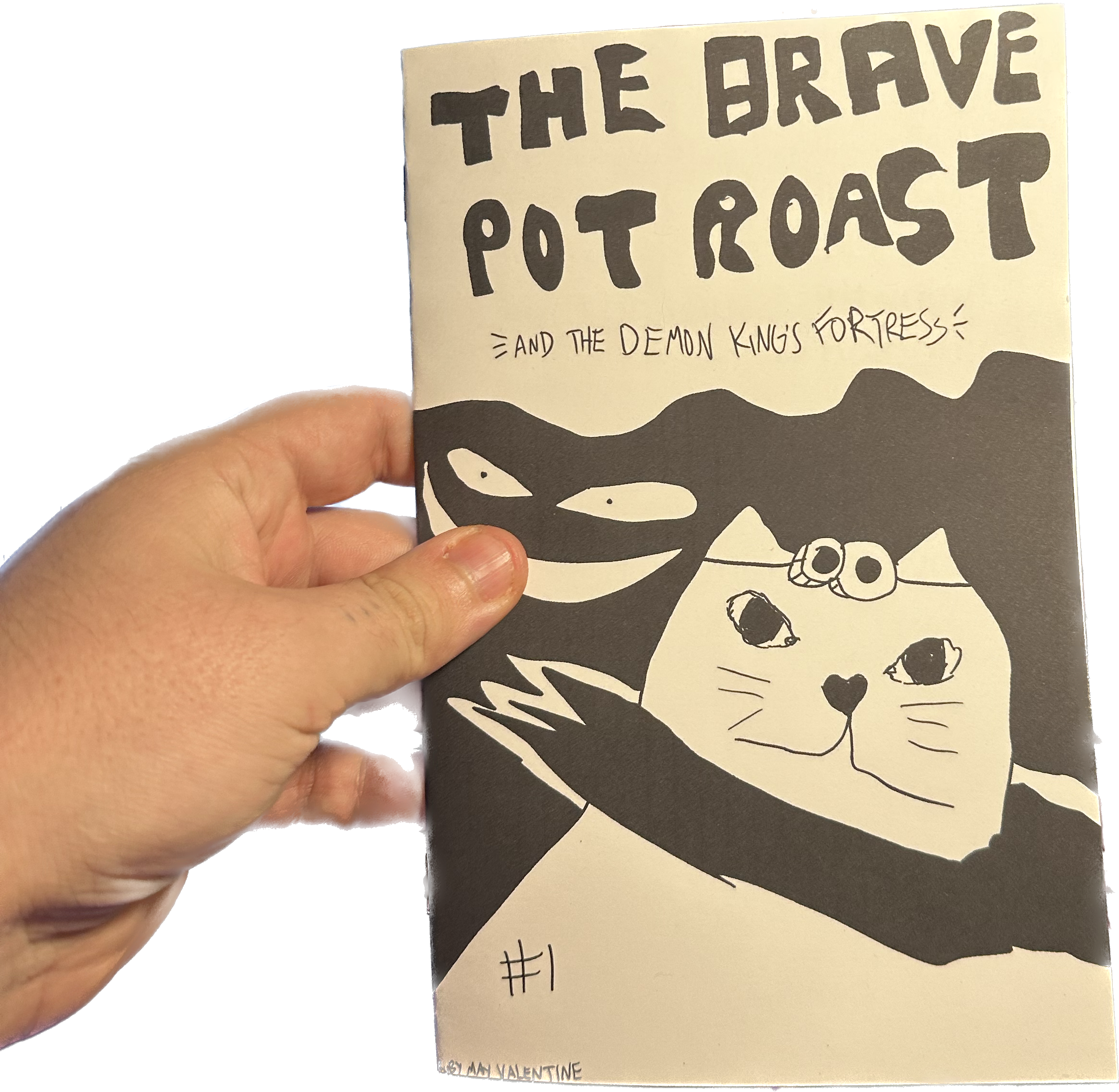 a picture of a cutout hand holding a copy of the brave pot roast #1 which shows a cat and a scary face on the cover