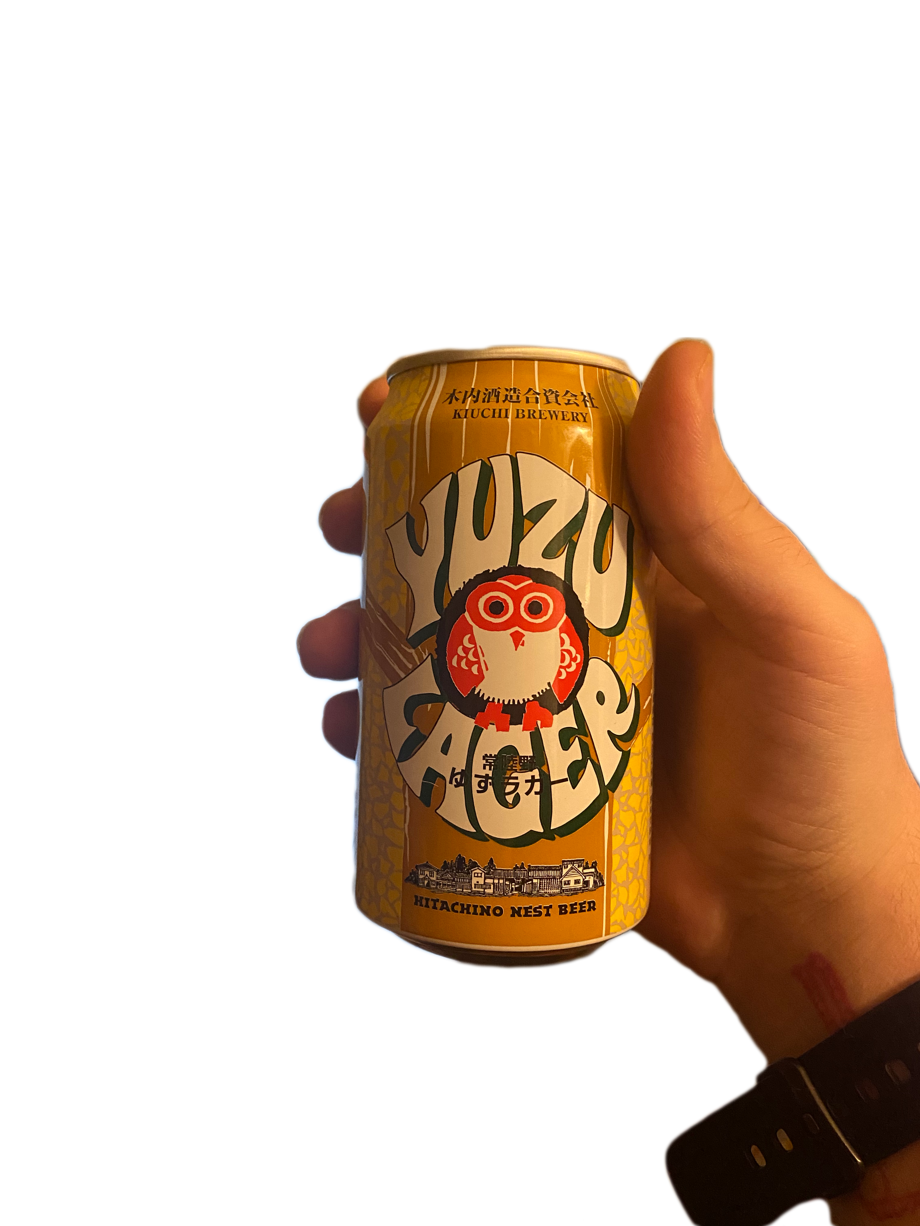 a cut out of my hand holding a can of beer, it says kiuchi brewery in japanese and english as well as YUZU LAGER, there is a cute owl between YUZU and LAGER, and it then says Hitachino Nest Beer below