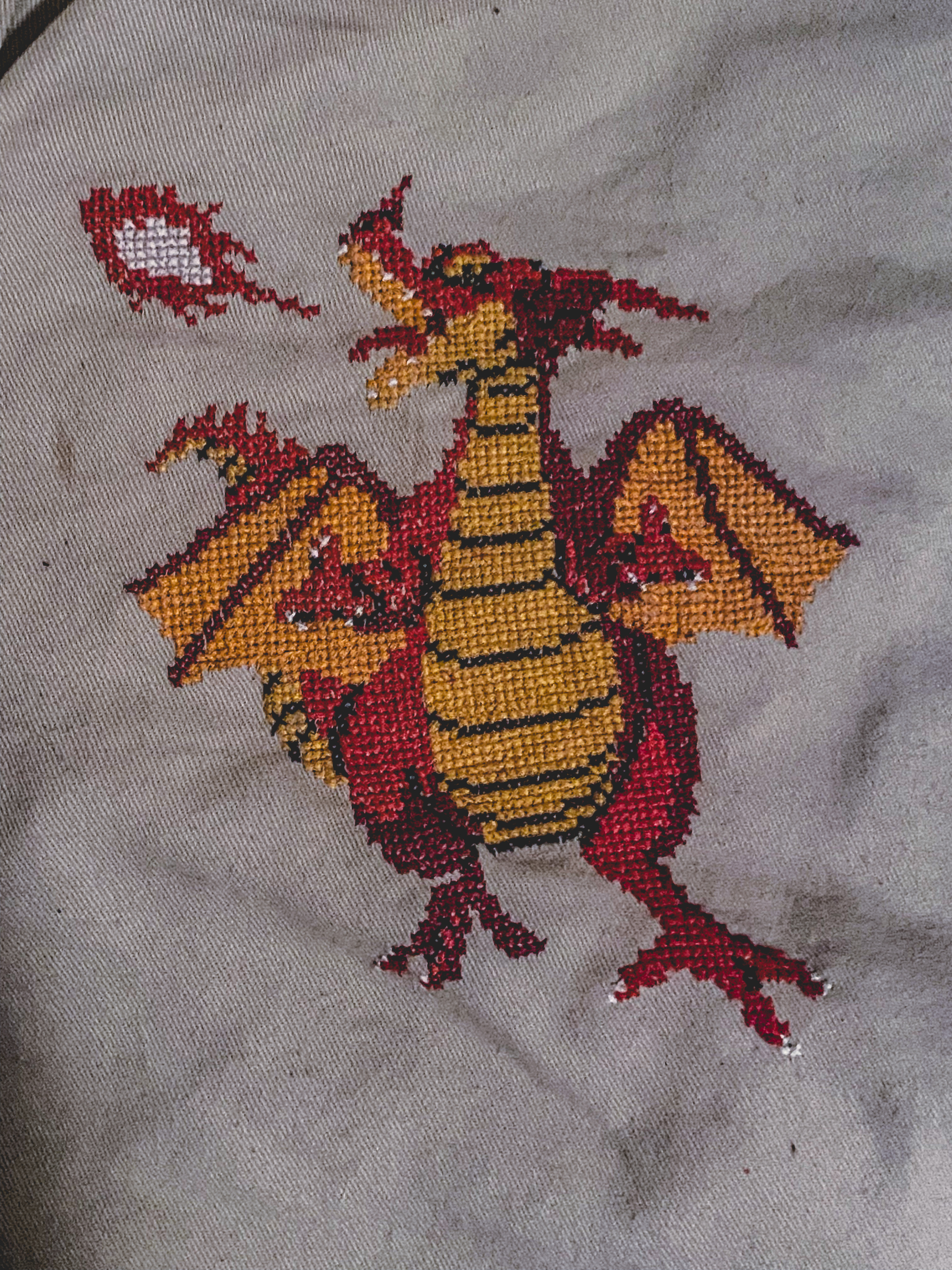 a cross stitch of king dragon from dragon quest